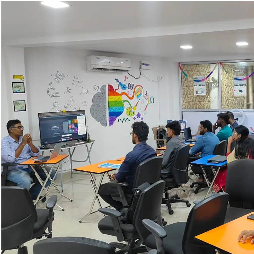 Mentor-led UX UI design class with students facing a large display